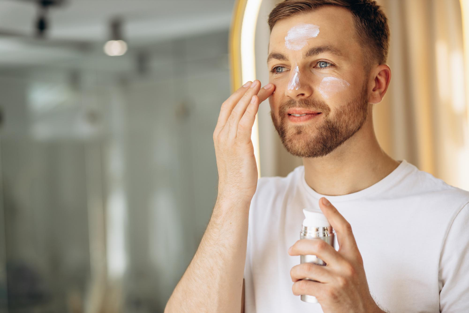 man-applying-face-cream-home